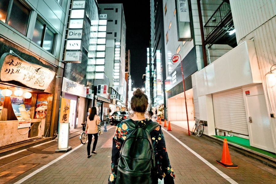Girl in the city at night in Japan