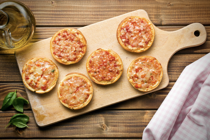 Kids making personal pizza