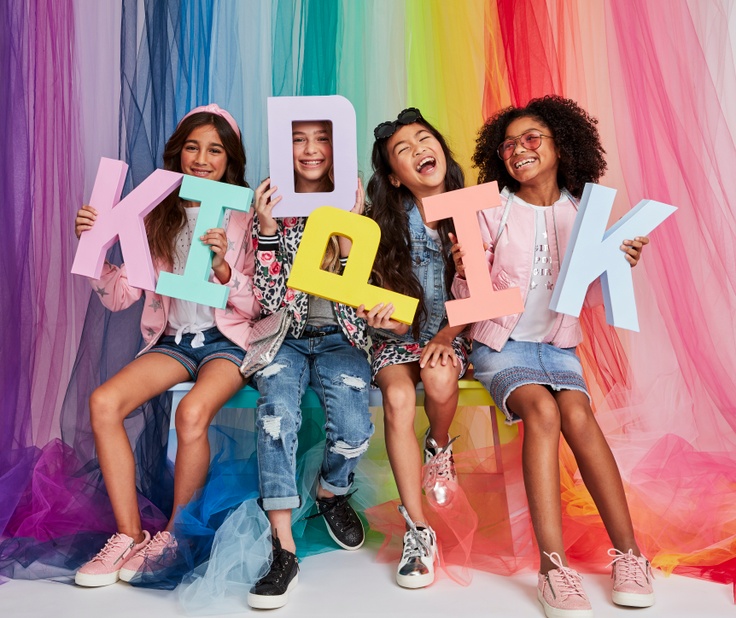 Girls holding kidpik letters