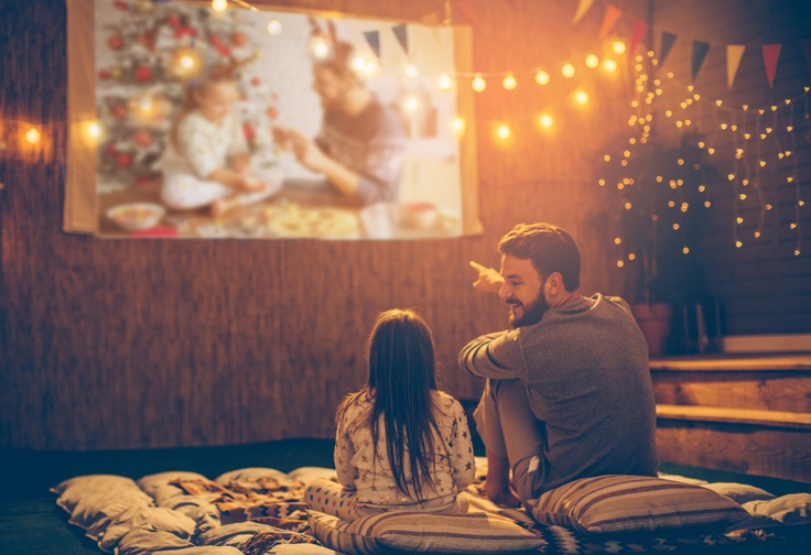 kid and dad having an outdoor movie night