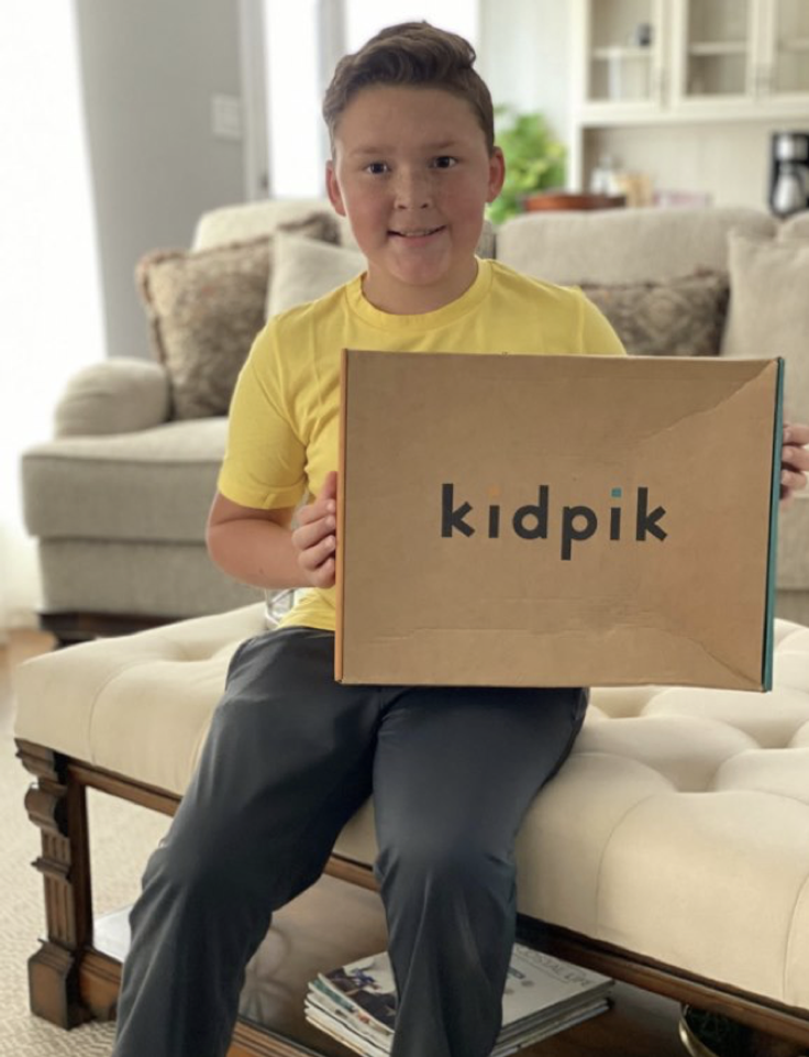 boy holding kidpik clothing box