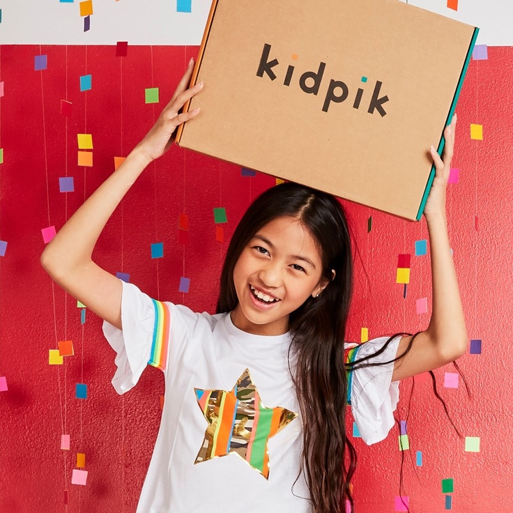 girl holding kidpik subscription box