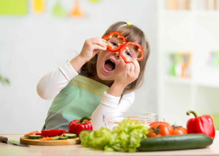 girl in kids clothes cooking