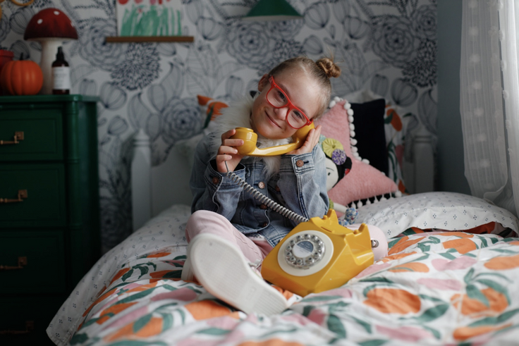 kid on toy phone in kidpik outfit