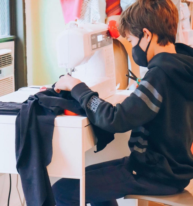 Boy sewing