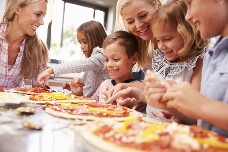 Kids making personal pizza