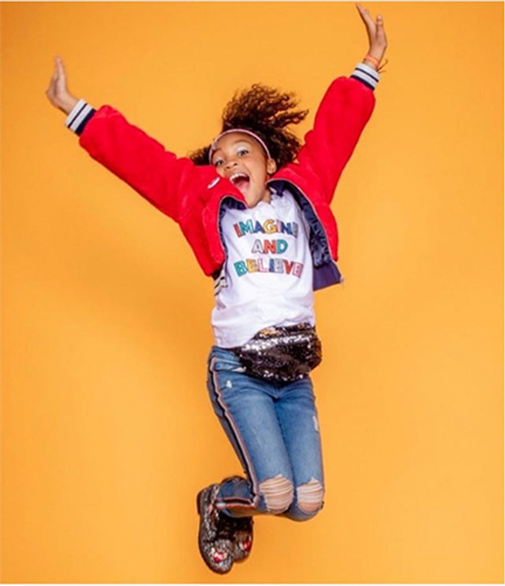 Alyssa jumping for joy while wearing kidpik