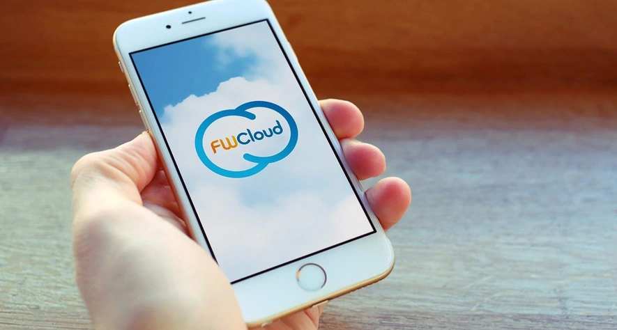 A hand holding a phone with the FWCloud logo